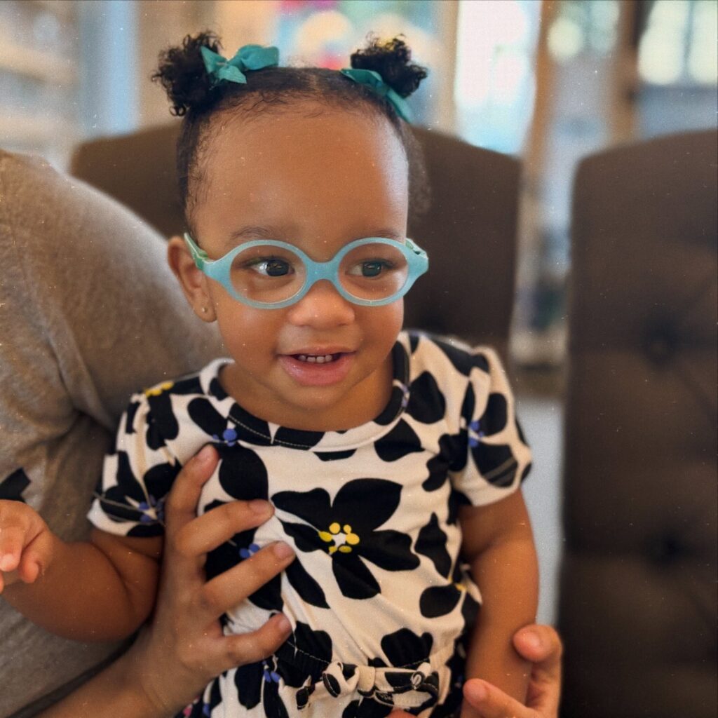 A girl baby with glasses