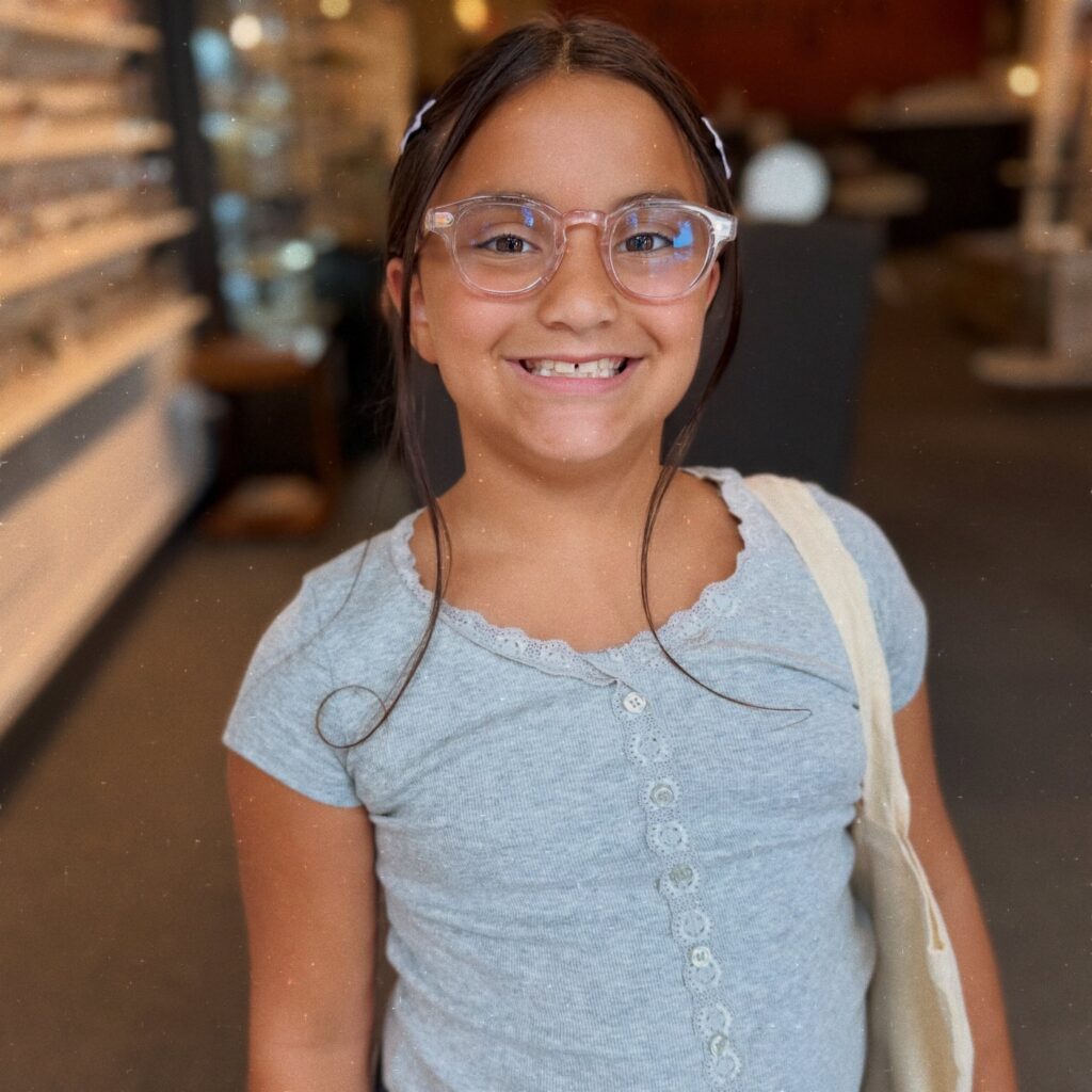 A girl smiling with glasses