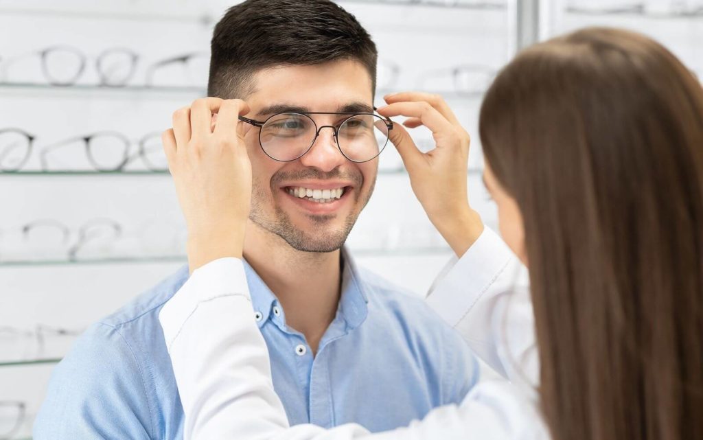 Eye doctor helping client choose glasses