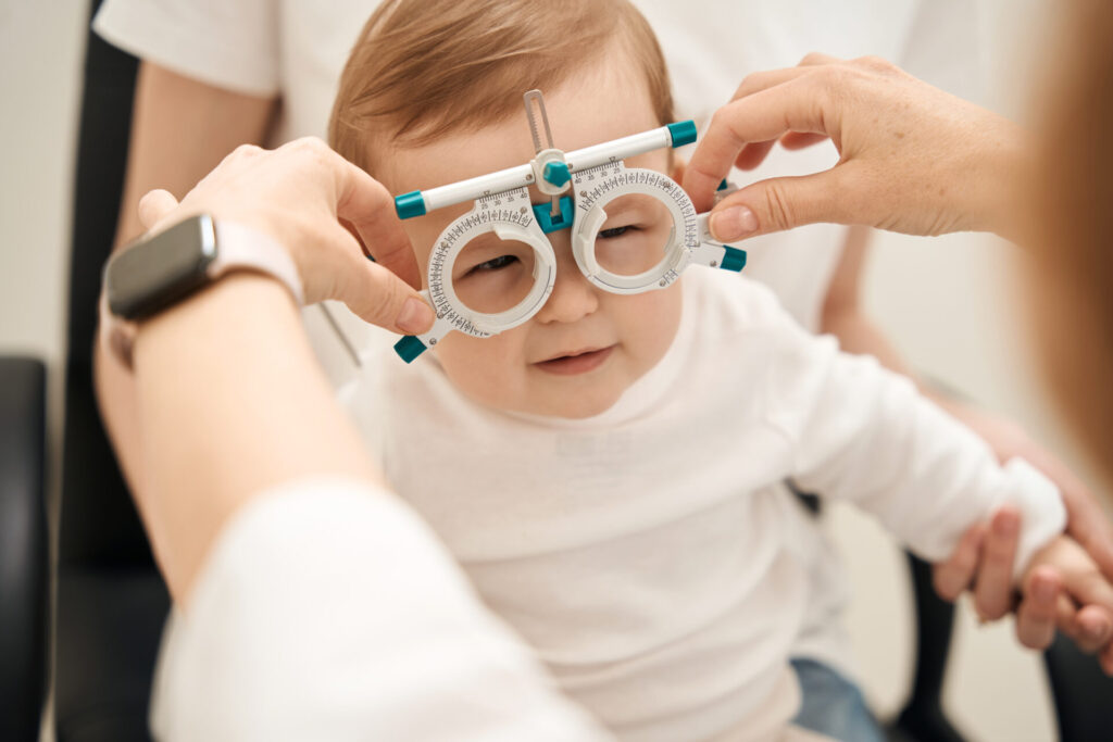 Eye-doctor-fitting-a-older-infant-boy-for-corrective-lenses